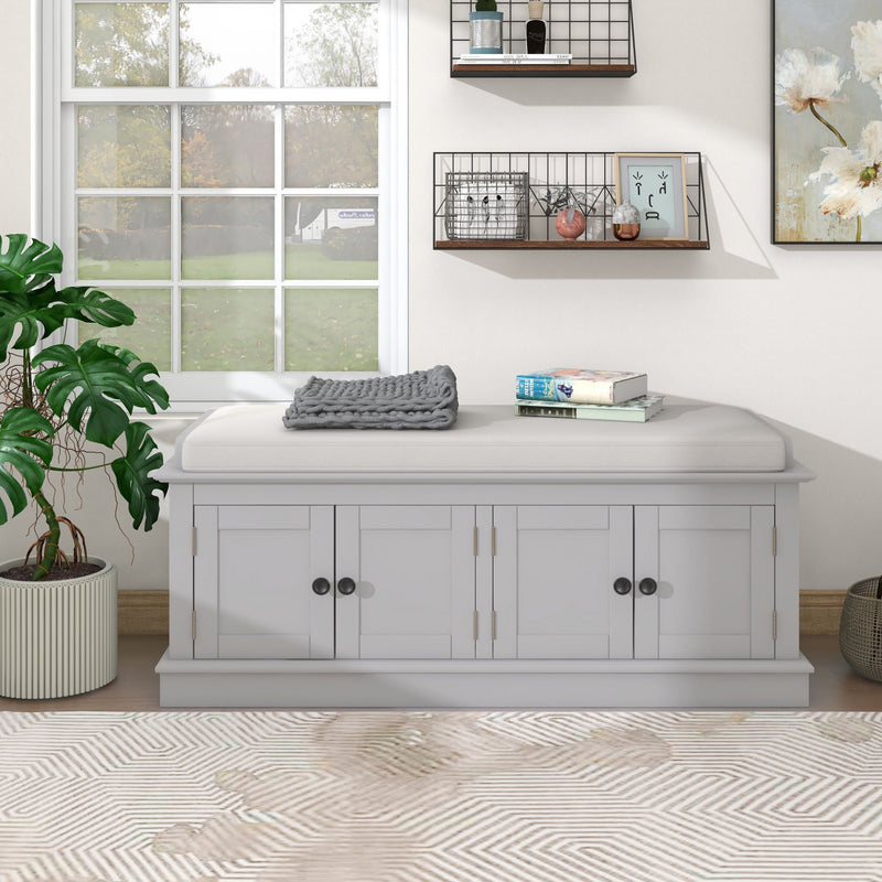 White four-door shoe storage bench with a padded removable cushion, shown from the front