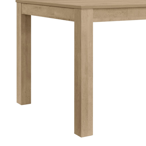 Rectangular dining table corner close-up in light brown wood-look finish