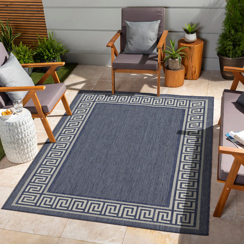 Dark gray indoor/outdoor area rug with blue Greek key border, polypropylene pile