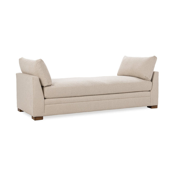Upholstered daybed with two back pillows, light beige upholstery, squared arms, wooden legs