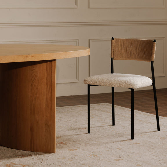 Foley dining chair with a textured white seat, woven tan back, and slim black metal legs
