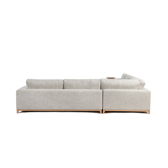 Light sand sectional sofa with square arms, tufted cushions, and wood legs.