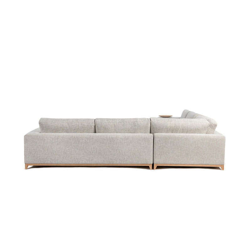 Light sand sectional sofa with square arms, tufted cushions, and wood legs.