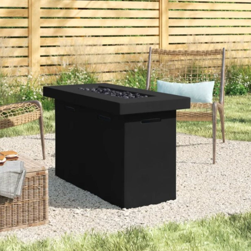 Dark outdoor propane fire pit table with black burner pan, stone bed, and side handles