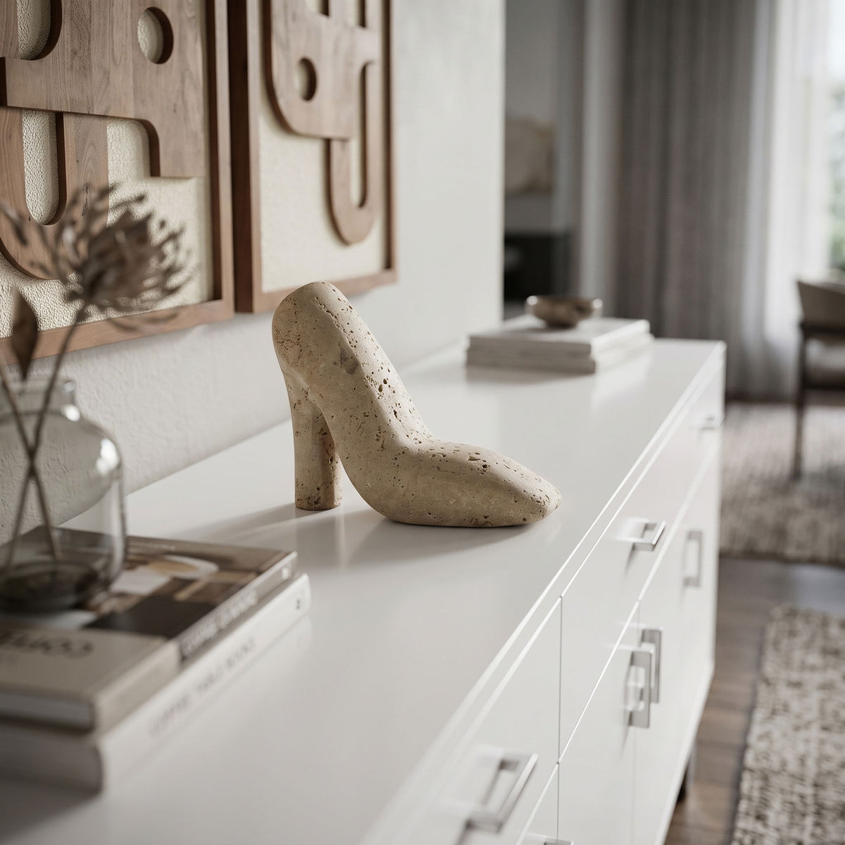 Beige high-heel shoe tabletop sculpture on a white console, speckled stone texture