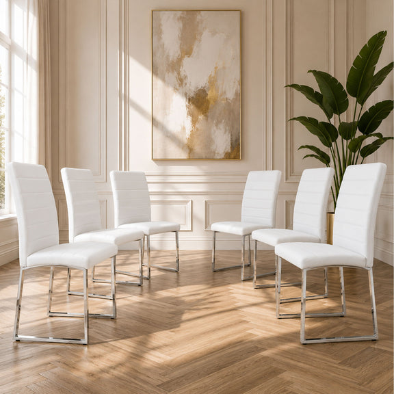 White upholstered dining chairs with curved backs and padded seats on chrome metal bases