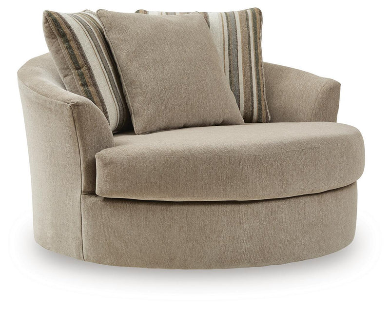 Oversized swivel accent chair in light beige fabric with two striped accent pillows