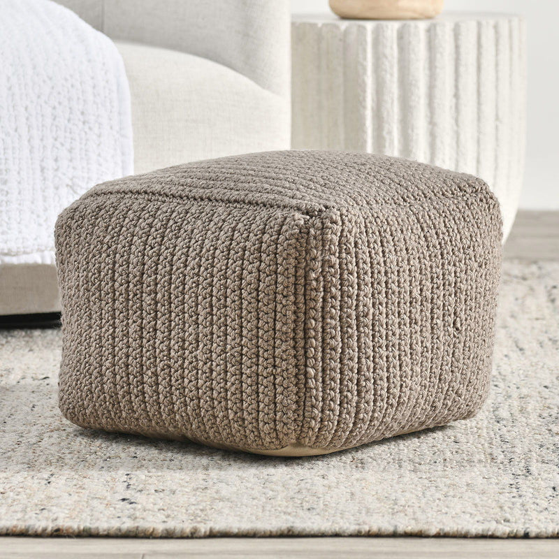 Prism pouf in natural woven knit, rounded cylindrical seat with seam detail