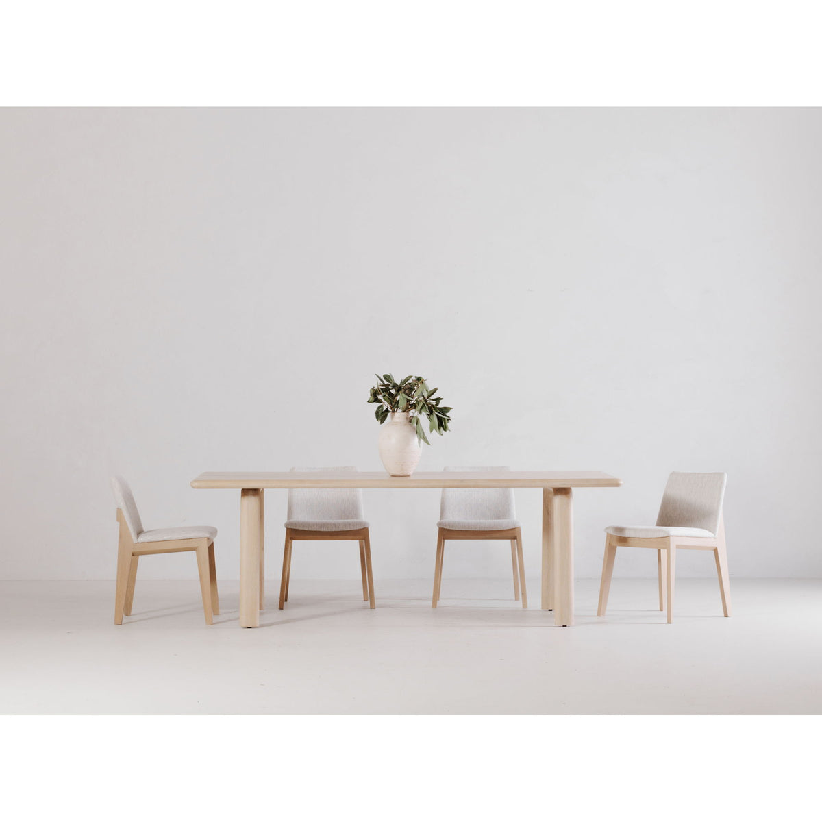 White oak dining table with slim apron and four straight legs