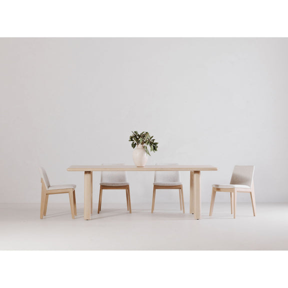 White oak dining table with slim apron and four straight legs