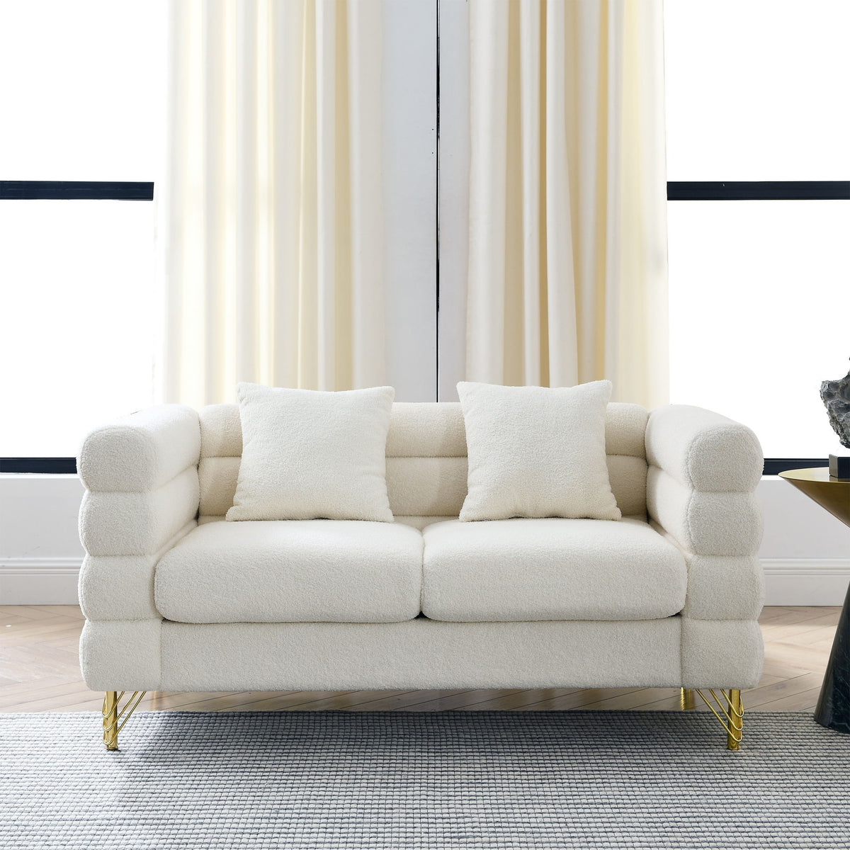 Light beige sectional sofa with three seat cushions, square arms, and gold metal legs.