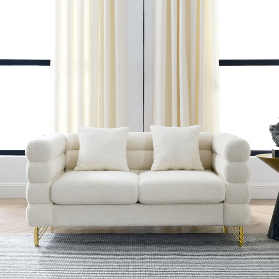 Light beige sectional sofa with three seat cushions, square arms, and gold metal legs.