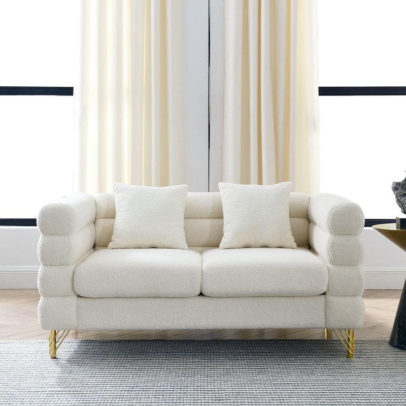 Light beige sectional sofa with three seat cushions, square arms, and gold metal legs.
