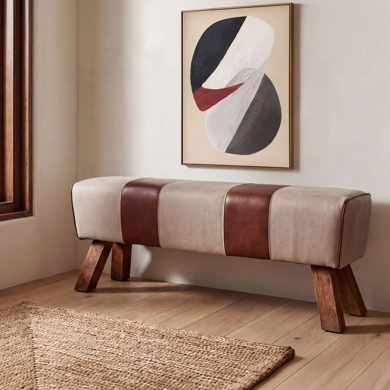 Patchwork upholstered bench with beige and brown seat, wooden legs.