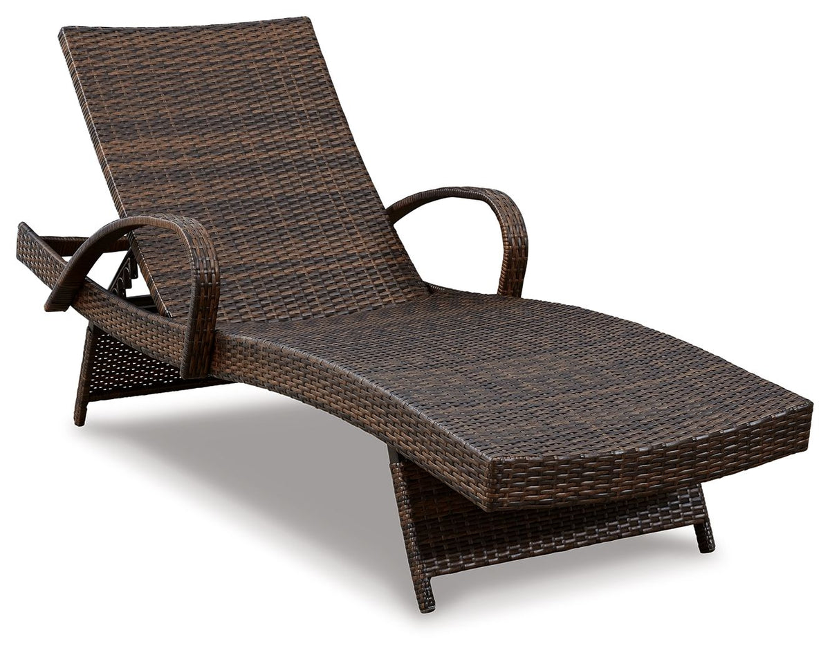 Brown woven chaise lounge chair with curved back and armrest, angled view