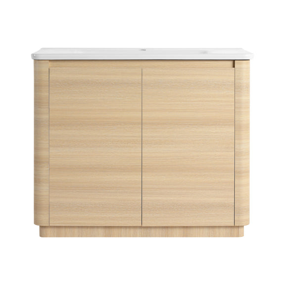 Freestanding bathroom vanity with white sink top and light brown two-door cabinet