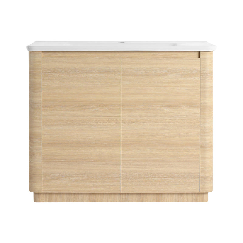 Freestanding bathroom vanity with white sink top and light brown two-door cabinet