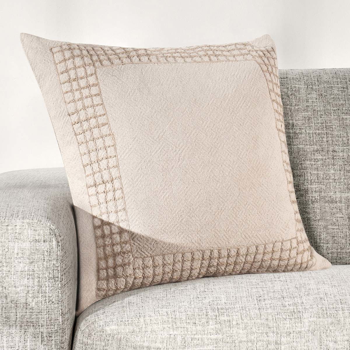Natural stitched throw pillow with textured border trim and center panel