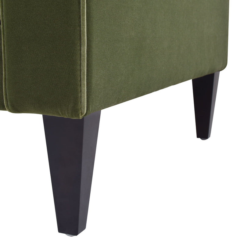 Olive green sofa with boxy skirt and dark tapered legs