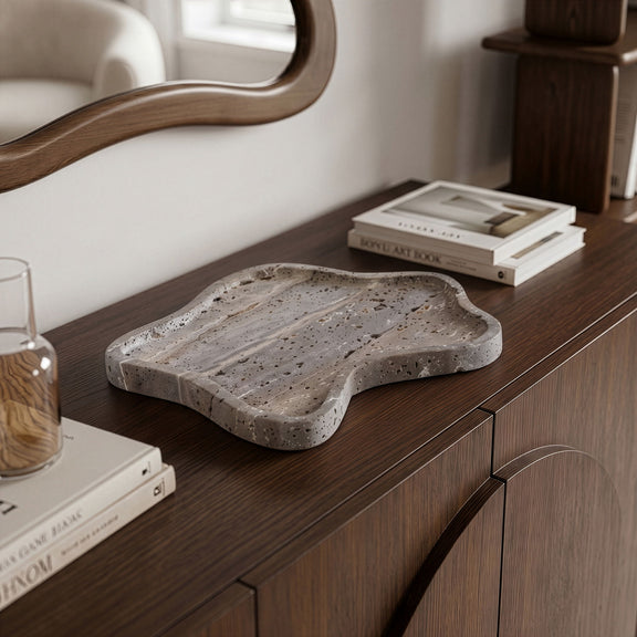 Gray speckled marble tray with organic shape and wavy rim for serving