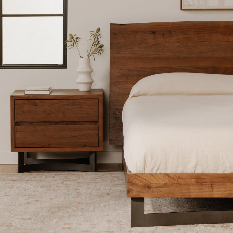 Smoked wood nightstand with two drawers and dark legs, corner view