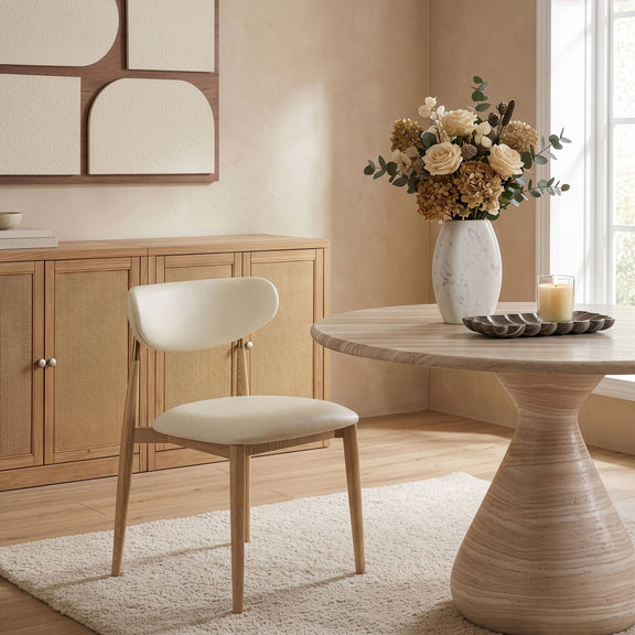 Vegan leather dining side chair with white cushioned seat and light wood legs