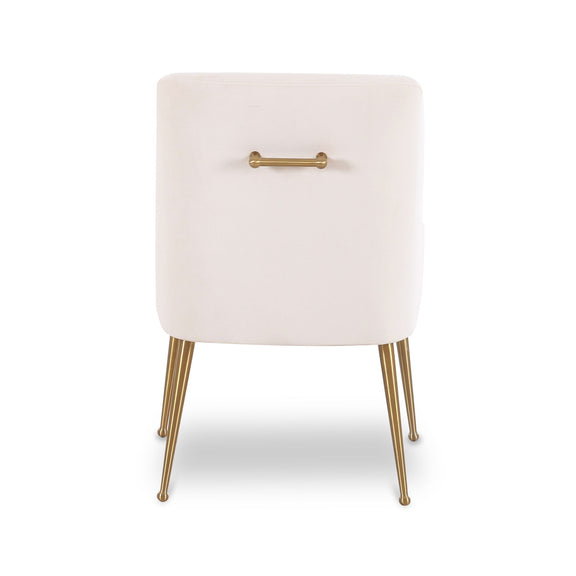 White velvet side chair with gold-toned handle detail and angled gold legs