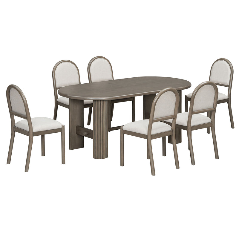 Dark brown oval dining table with six upholstered chairs, arched backs and fabric seats