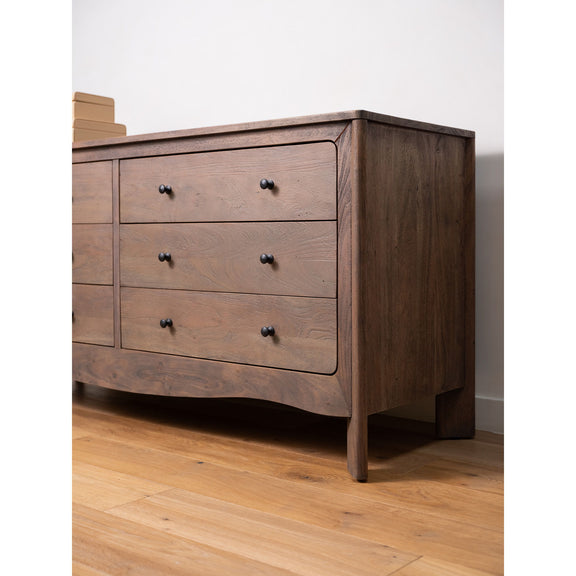Dark brown 6-drawer dresser with black knobs and curved front edges on legs