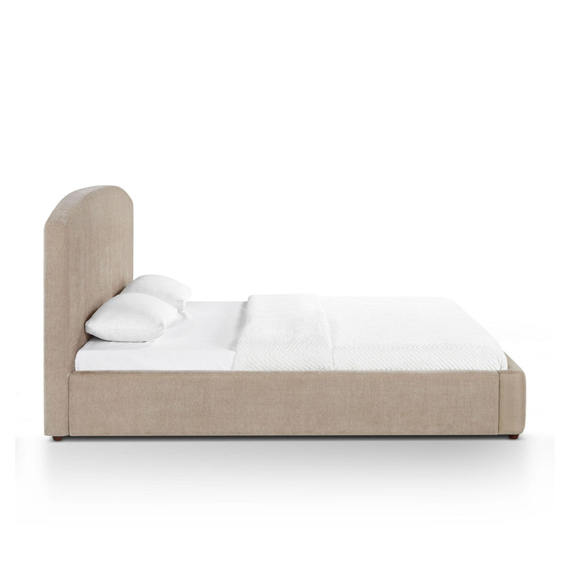Upholstered bed with tall headboard, light brown frame, white bedding and pillows