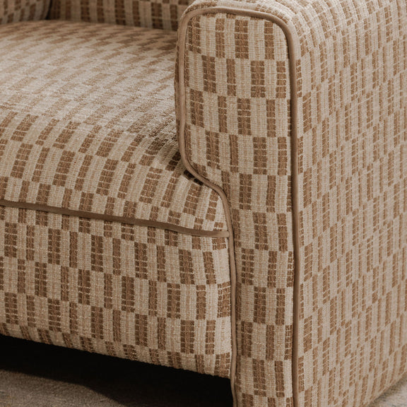 Taupe accent chair armrest with geometric woven fabric and rounded padded edge