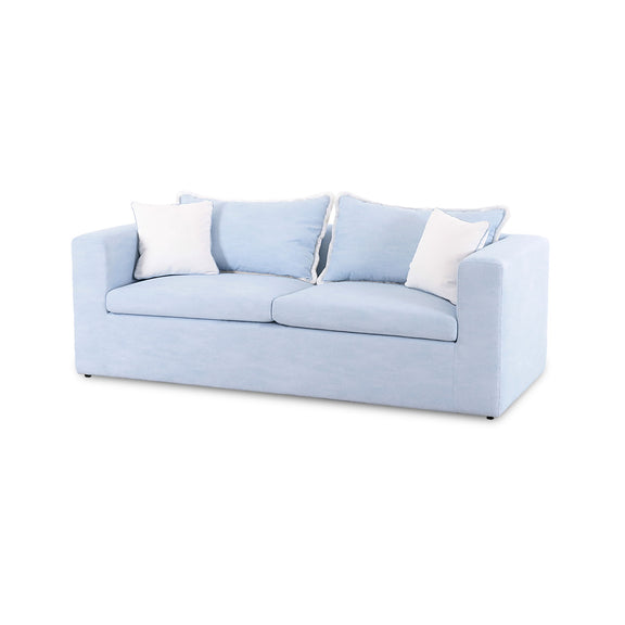 Light blue boucle outdoor sofa with two seat cushions, three pillows, and white throw accents