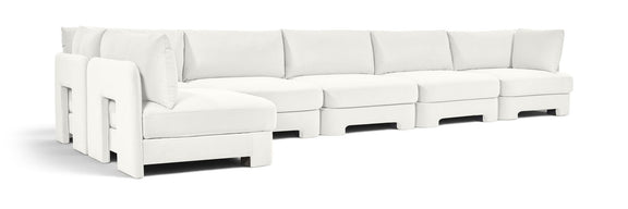 White L-shaped armless sectional sofa with velvet-style upholstery and boxy back cushions