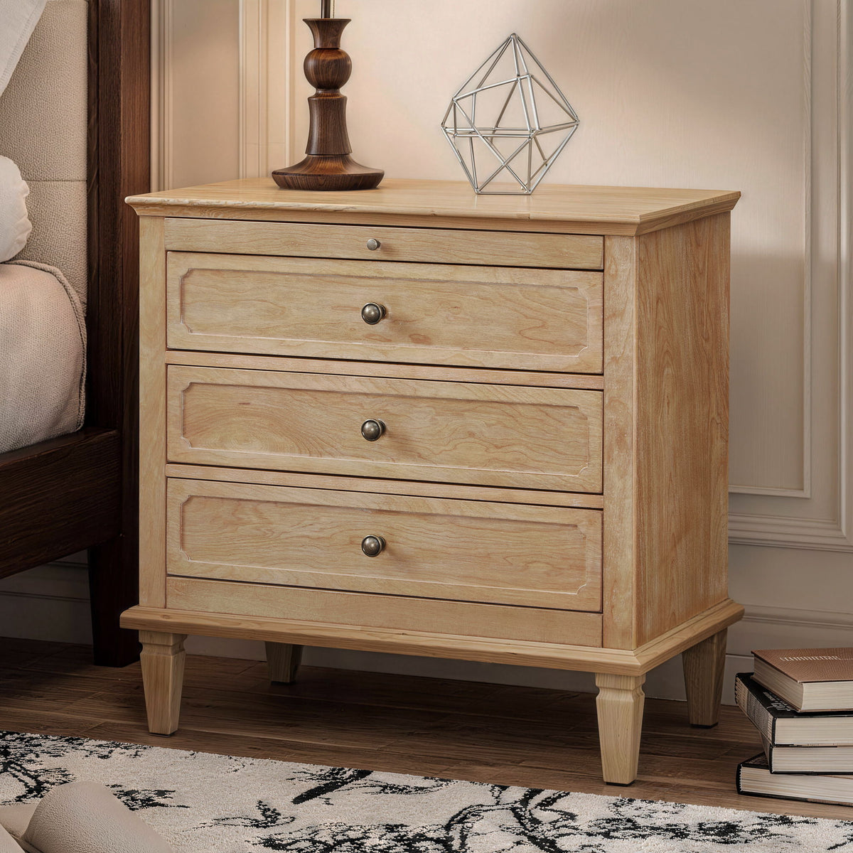 Light brown three-drawer nightstand with decorative drawer fronts and paneled side