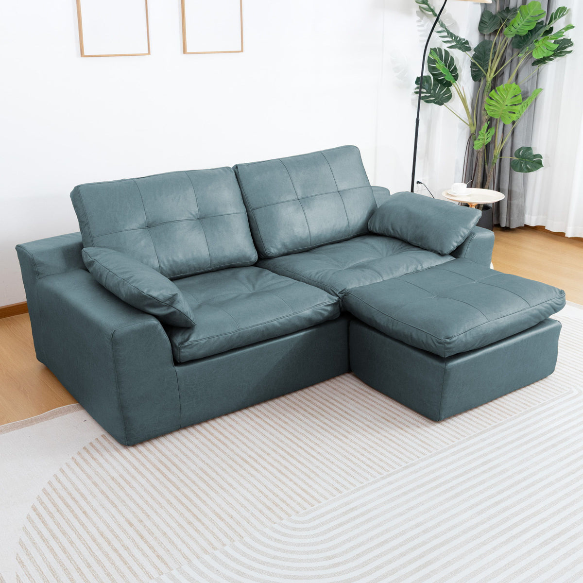 Blue L-shaped sofa with movable ottoman; cushioned backrests and padded seat cushions