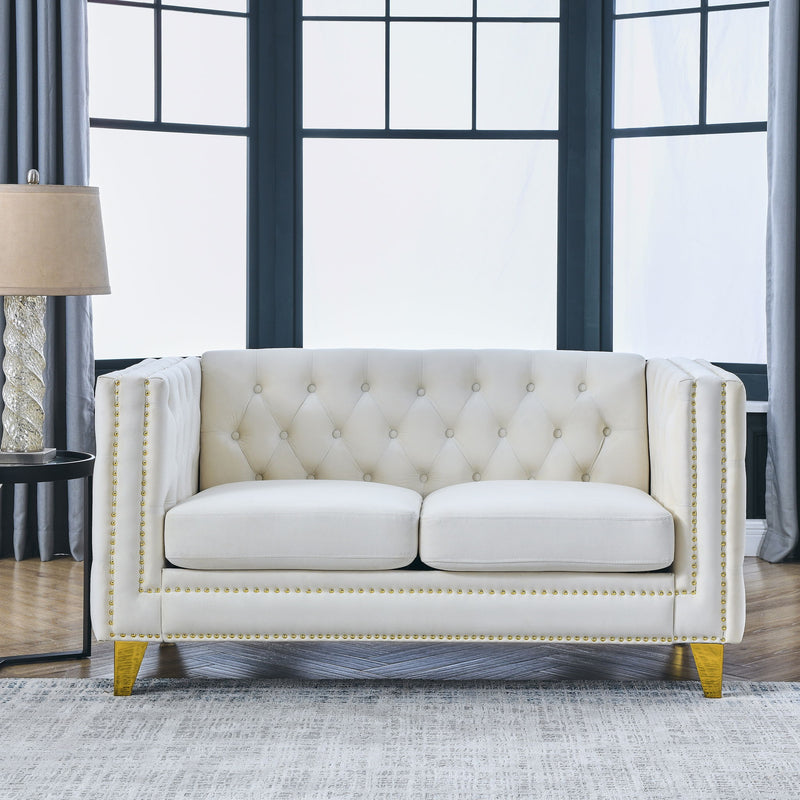 Beige button-tufted sofa with rolled arms, nailhead trim, and wood legs
