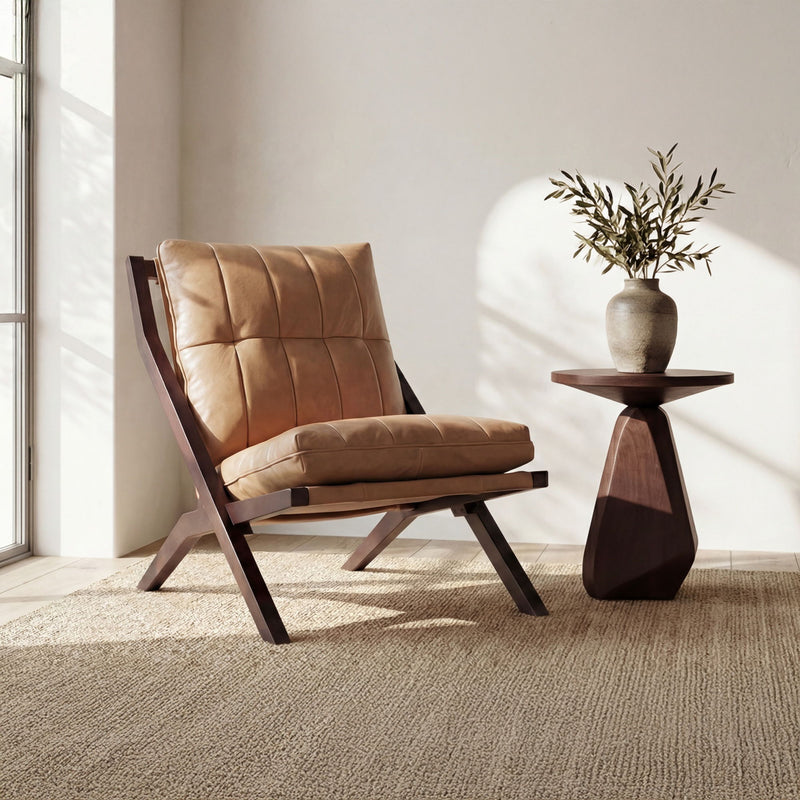 Tan leather-look accent chair with deep tufted back, angled wooden frame, cushioned seat