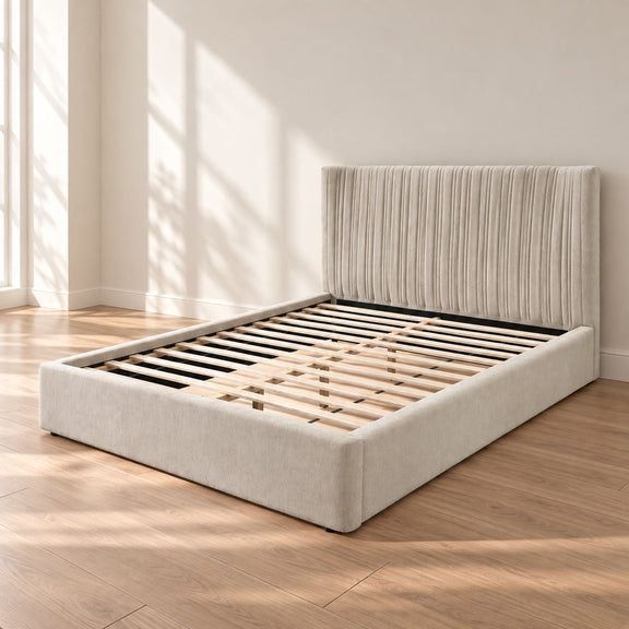 Beige upholstered bed with ribbed headboard and slat platform base
