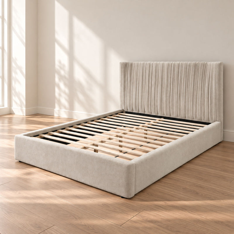 Beige upholstered bed with ribbed headboard and slat platform base