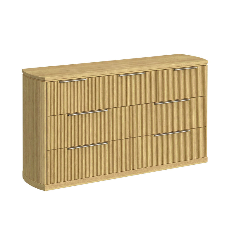 Light brown wood dresser with vertical slat panels and four drawers with bar pulls