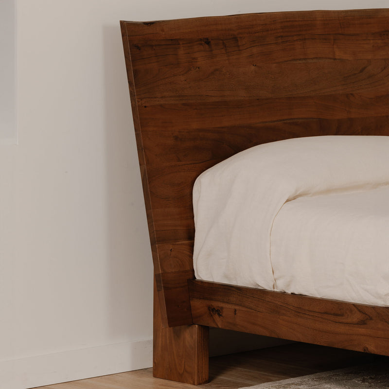 Queen bed with smoked wood headboard and curved side posts, white mattress