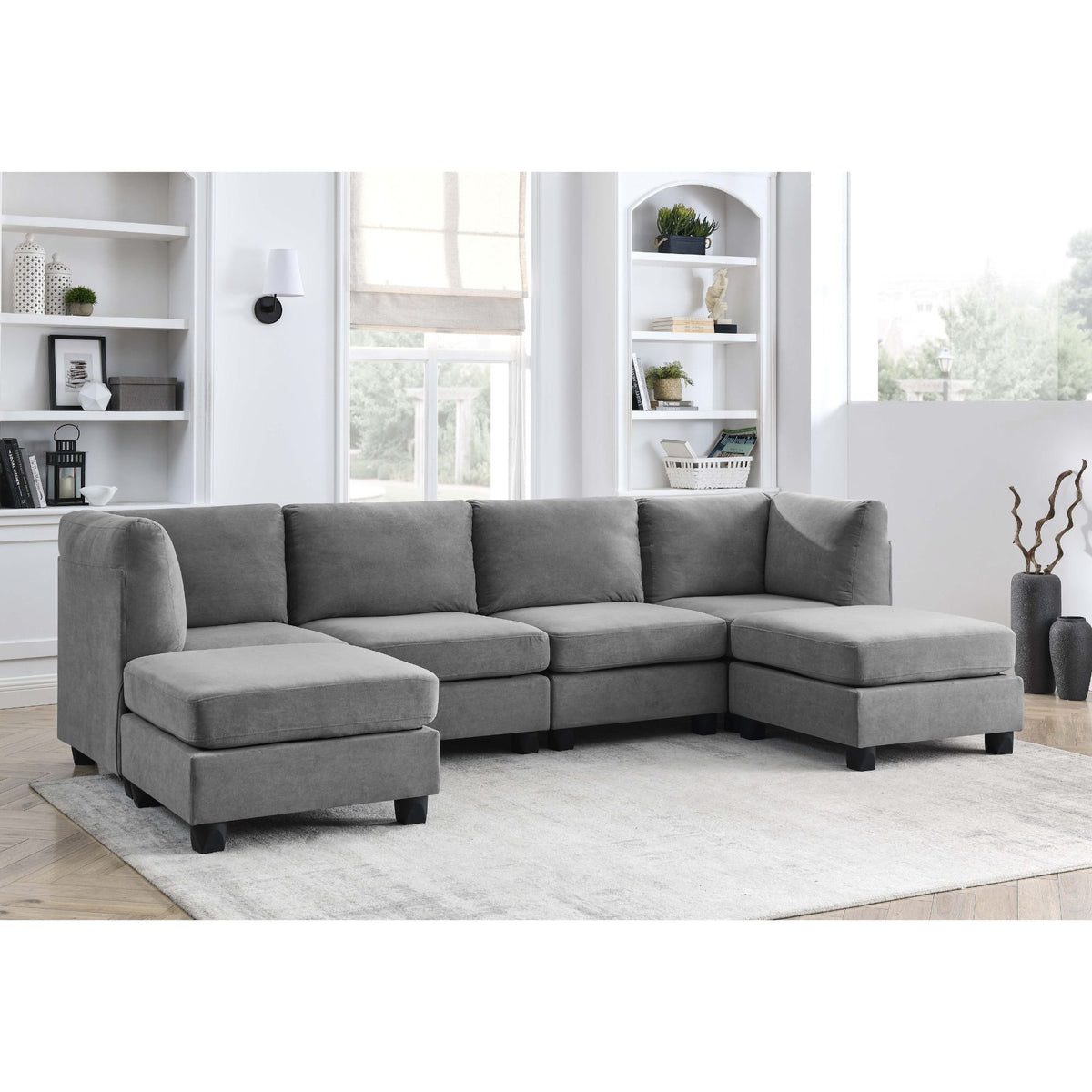 Upholstered modular sectional sofa in gray with chaise and extended ottoman-style seat