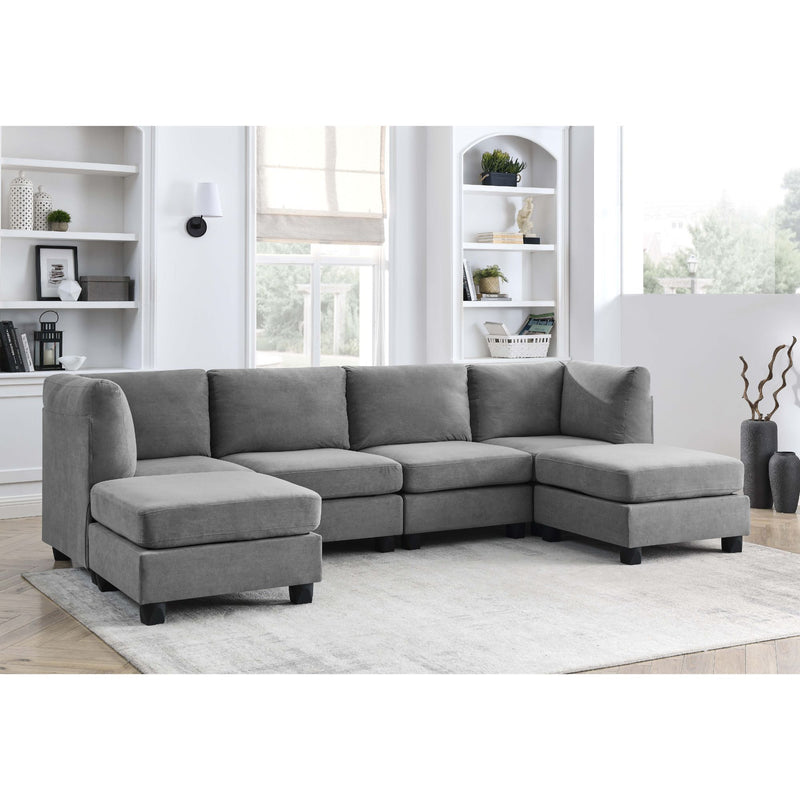 Upholstered modular sectional sofa in gray with chaise and extended ottoman-style seat