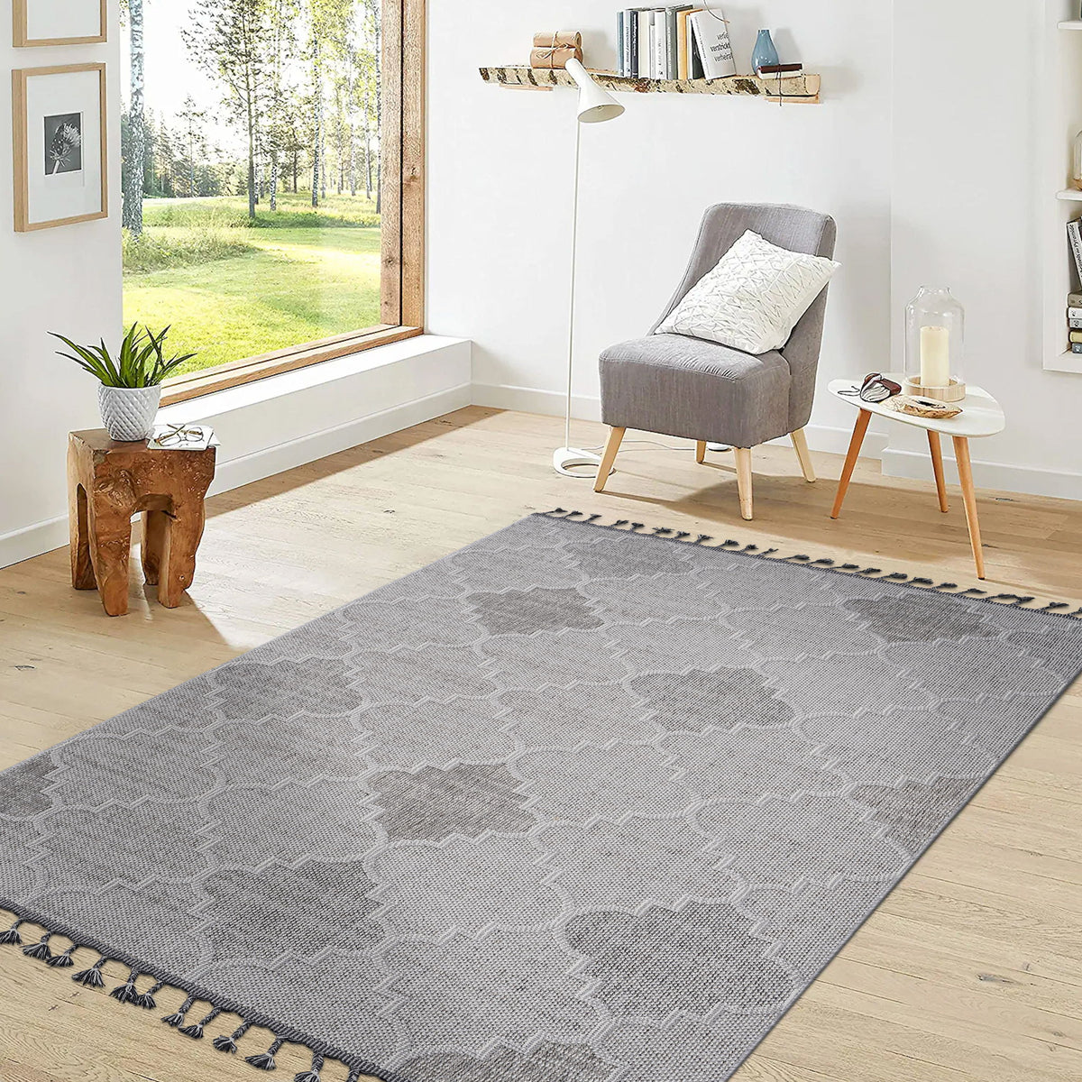 Trellis pattern gray area rug laid flat with dark outline and tassel fringe