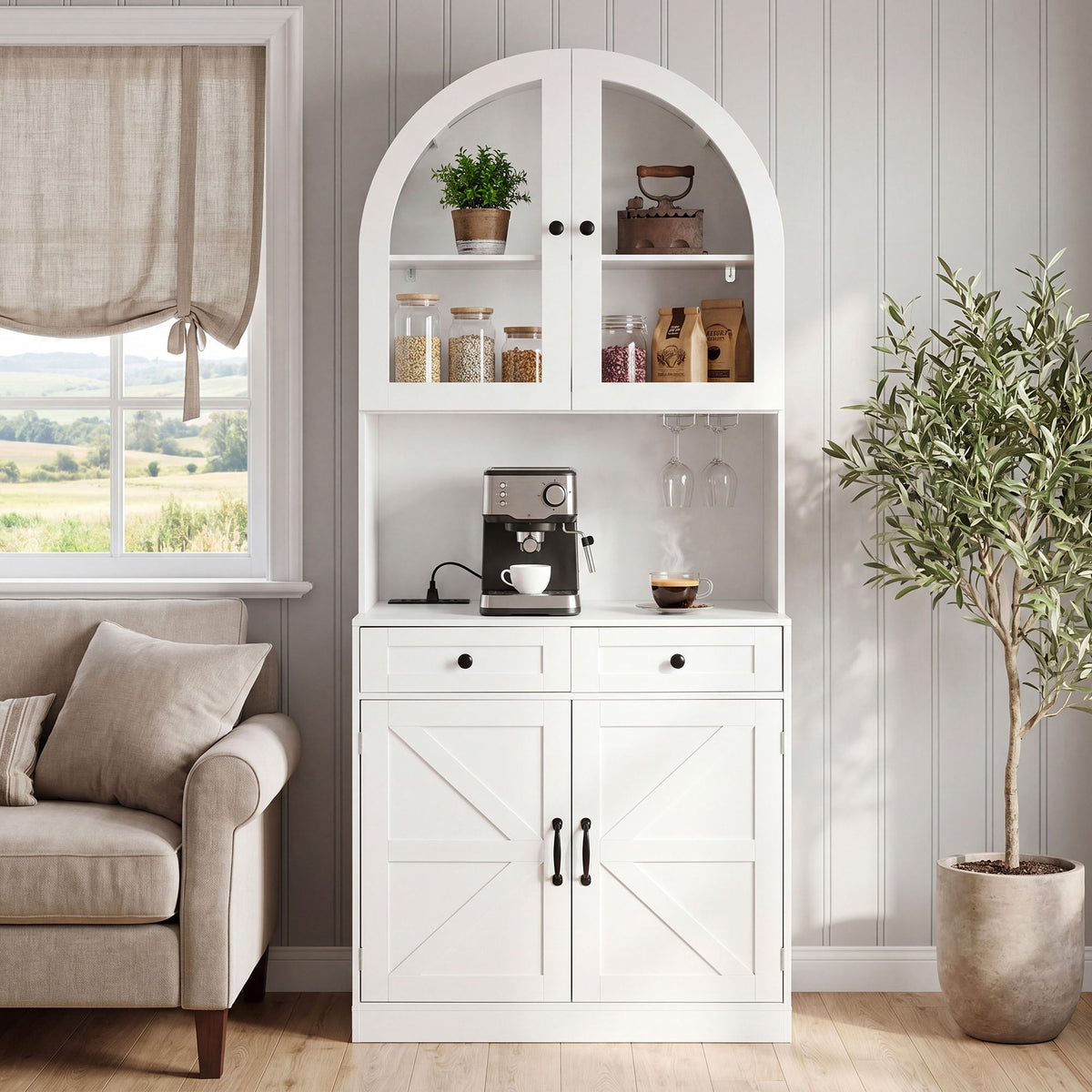 White arched pantry cabinet with glass-front shelves, open counter, two drawers and cross-panel doors