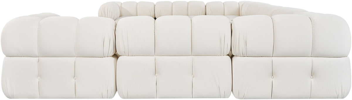 White velvet sectional sofa with tufted cushions, soft rounded arms, and back pillows