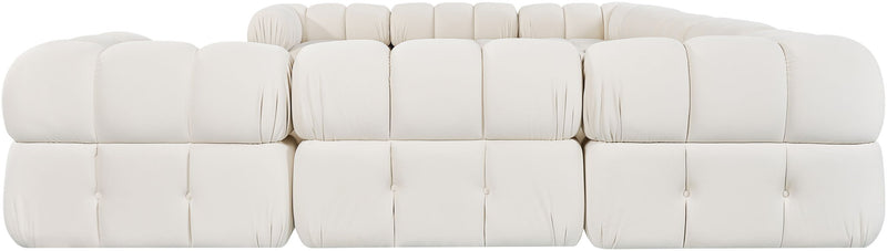 White velvet sectional sofa with tufted cushions, soft rounded arms, and back pillows