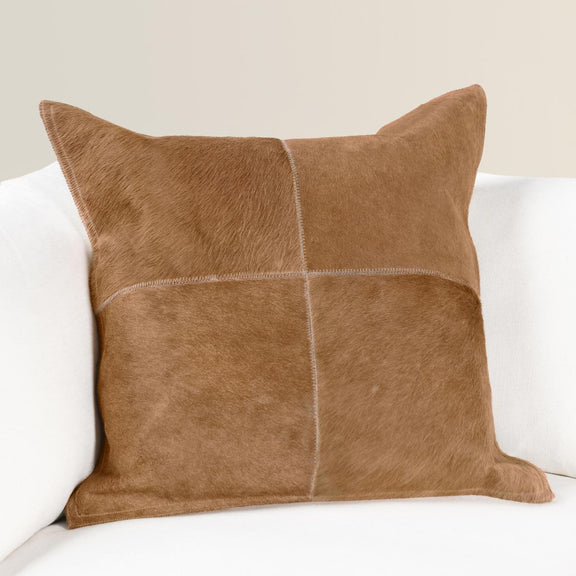 Tan hide pillow, front with four stitched quadrants and textured fur surface