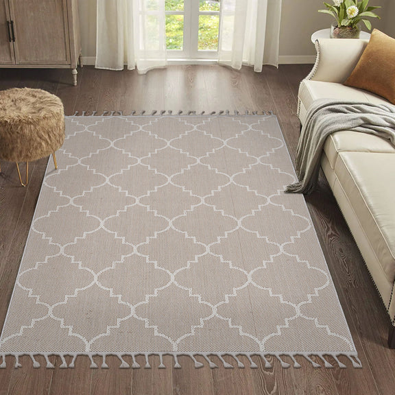 Beige trellis area rug with white geometric lattice pattern and tassel fringe.