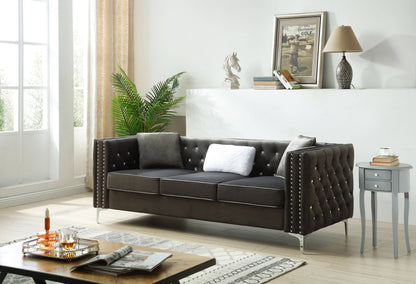 Dark gray tufted sofa with nailhead trim and squared arms, includes white throw pillows.